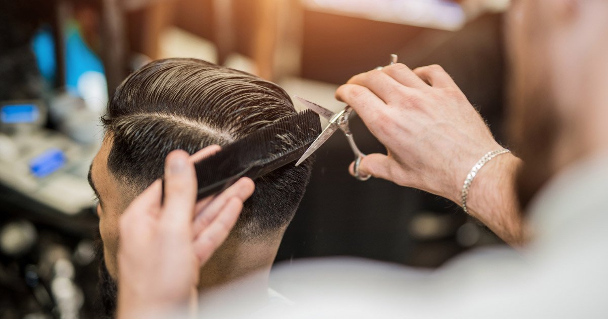Barber shaping a clean modern haircut with precision