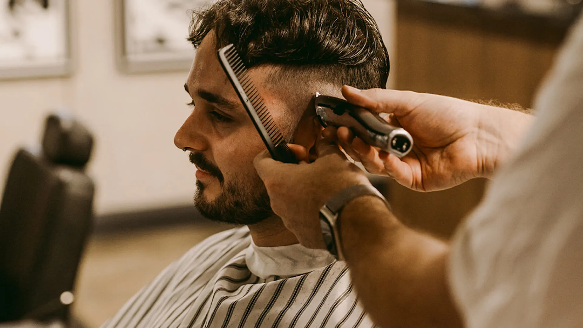 Barber preparing a tailored haircut in a contemporary barbershop