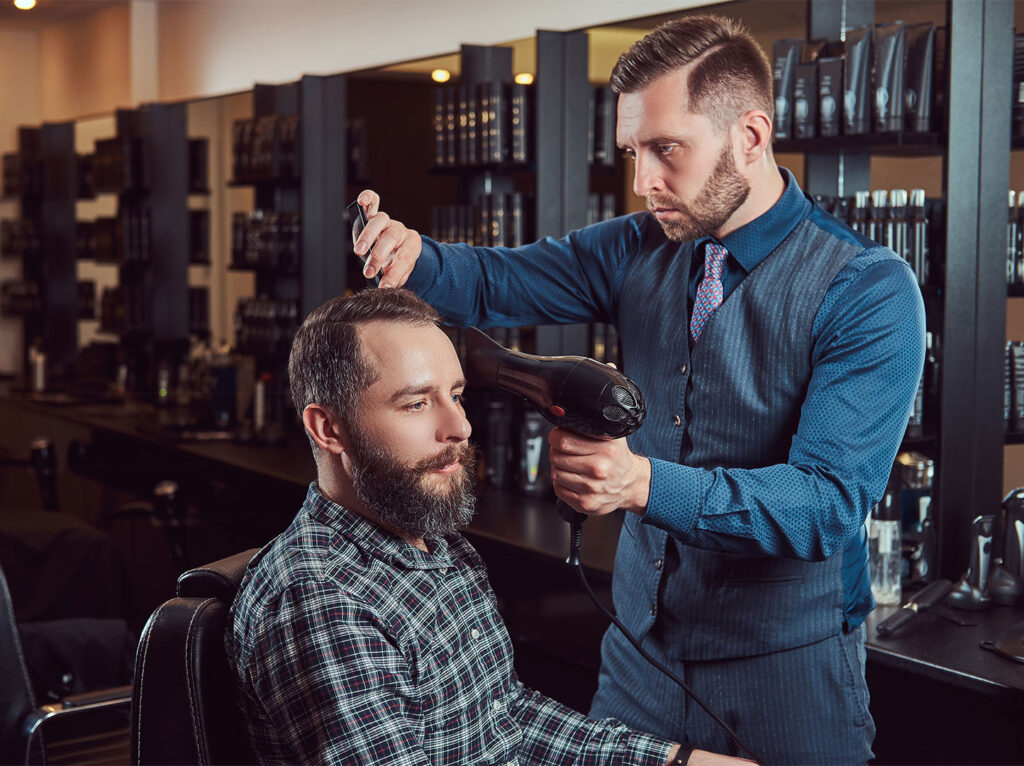 Illustrated phone screen showing a The Blade barber appointment form