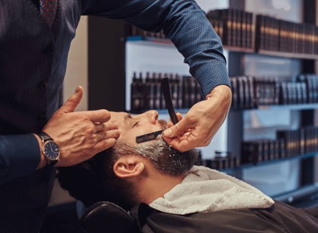 Illustrated entrance and interior of The Blade barbershop